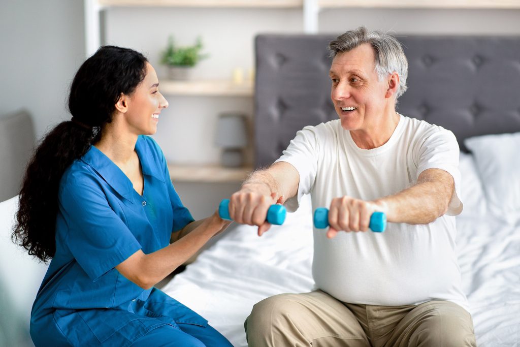 In-home physical therapist helps a patient at home In-home physical therapist helps a patient at home